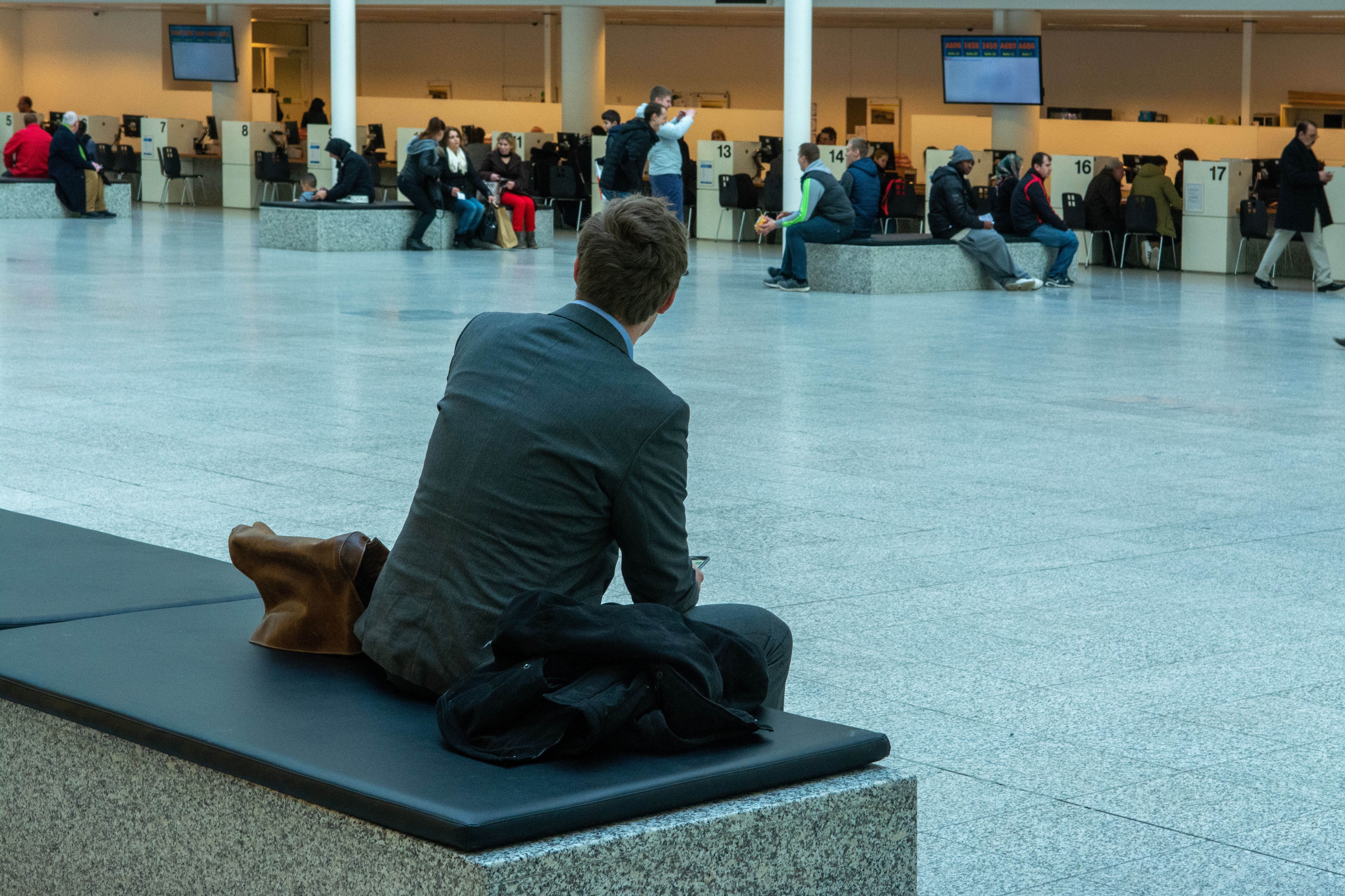 Business traveler with a laptop bag in an airport departure lounge